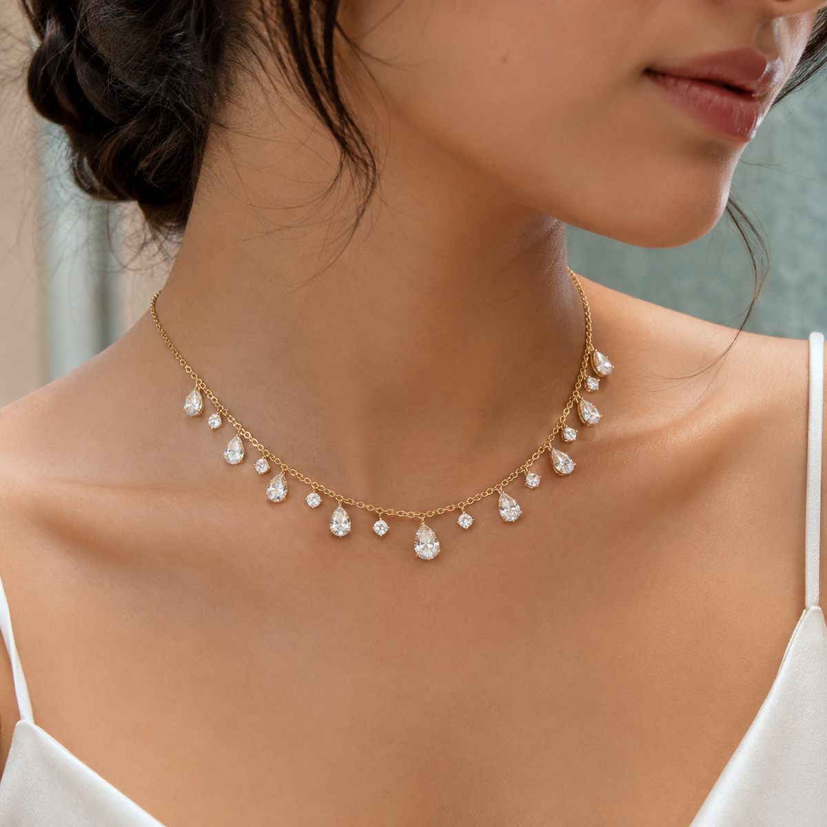 Pear and round shape lab-grown diamond dancing pendant necklace on a delicate gold chain on model