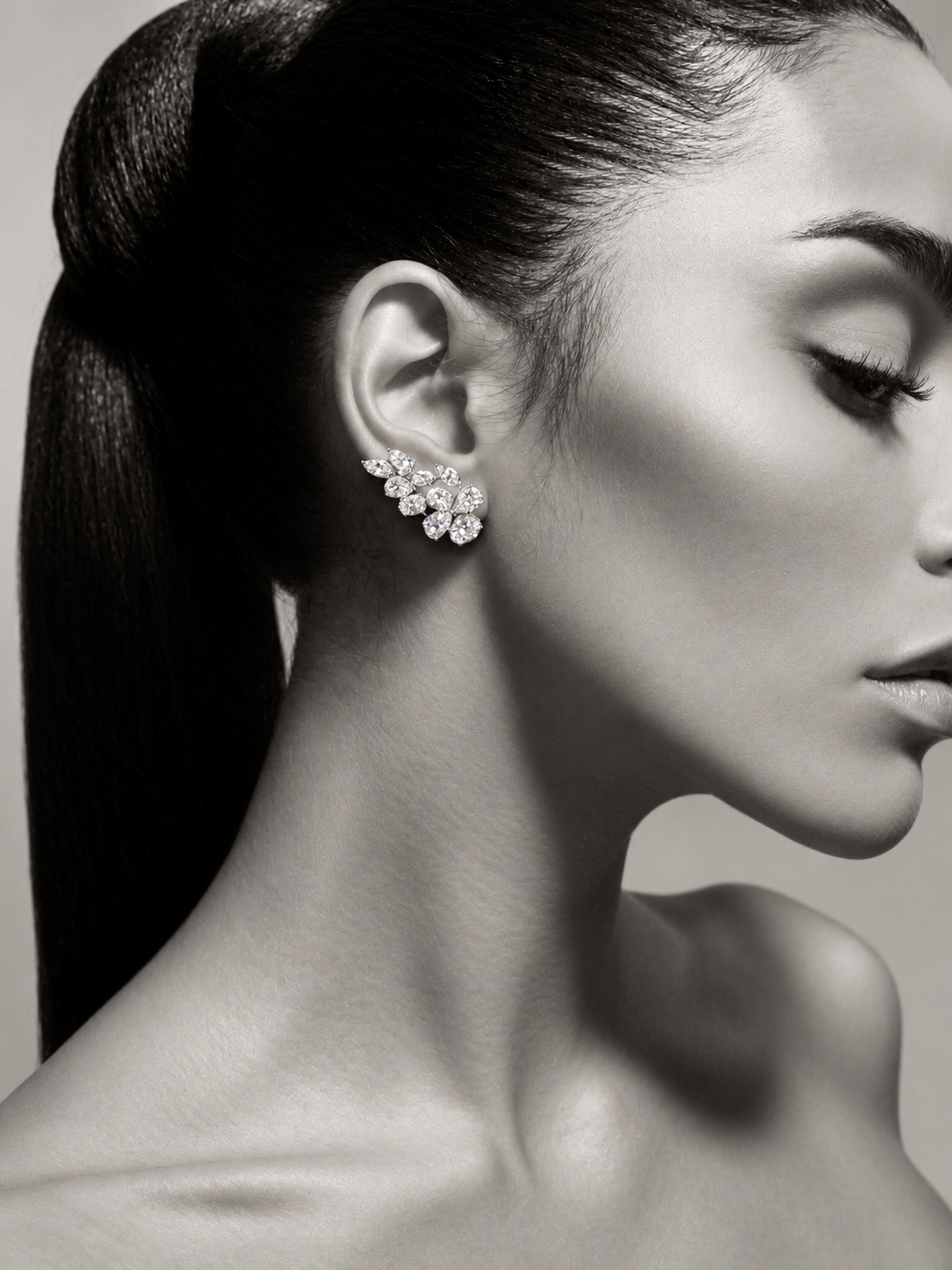 Monochrome model wearing Trellis Éclat multi-shape lab-grown diamond earrings set in 18k white gold